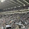 fans waving scarves pre match milburn stand sjp newcastle united nufc 1120 768x432 1